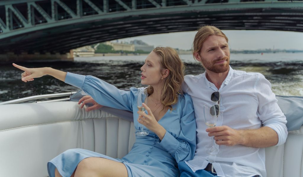 A couple enjoying the boat tour with luxury wine.
