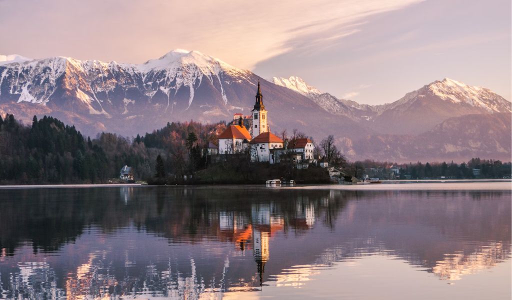 A view of the Slovenia lake with beautiful mountains in the background.