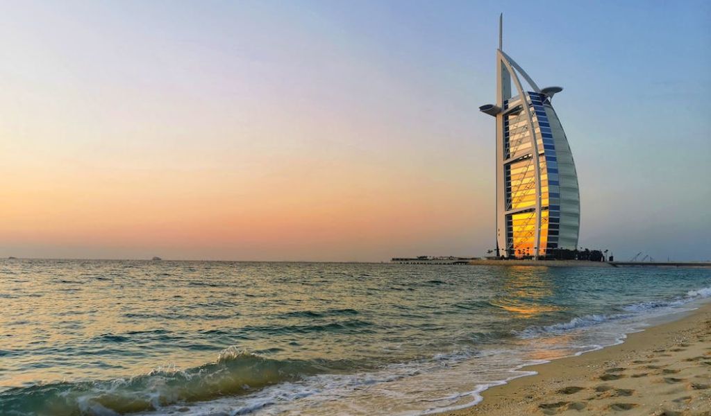 View of the Burj Al-arab from the beach with a beautiful sunset.