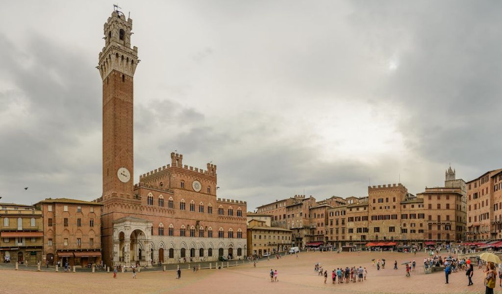 Tourists visiting the Piazza del Campo, Siena, Tuscany, Italy.