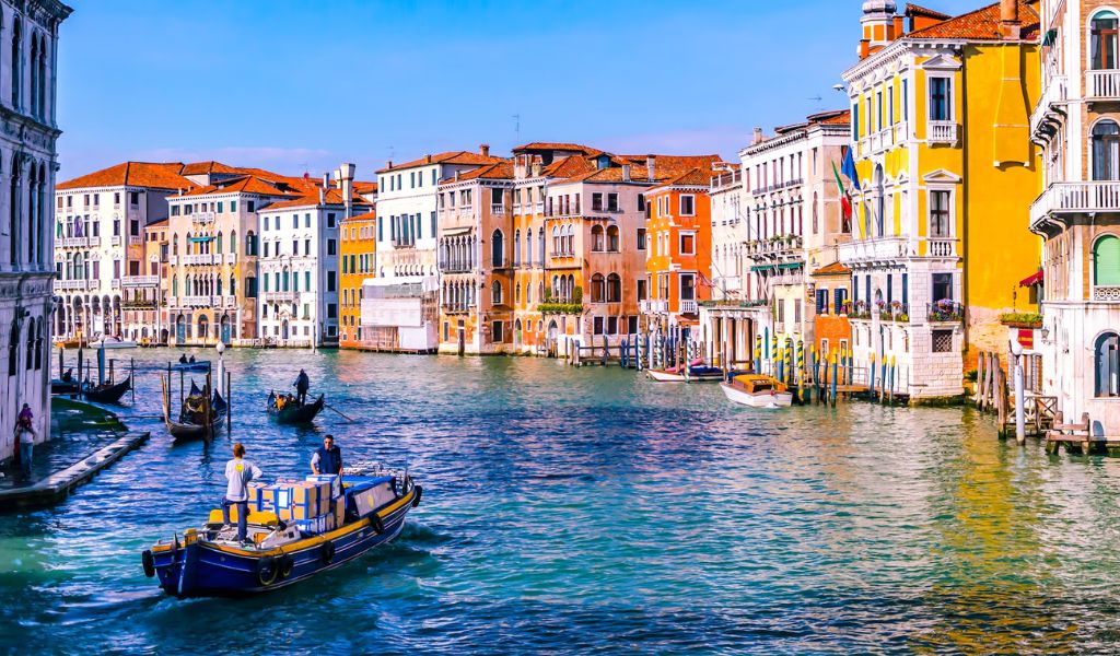 A beautiful Venice Canal with colorful houses and People on a Gondola