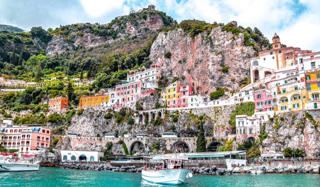 A colorful house in front of a rocky mountain in Amalfi coast