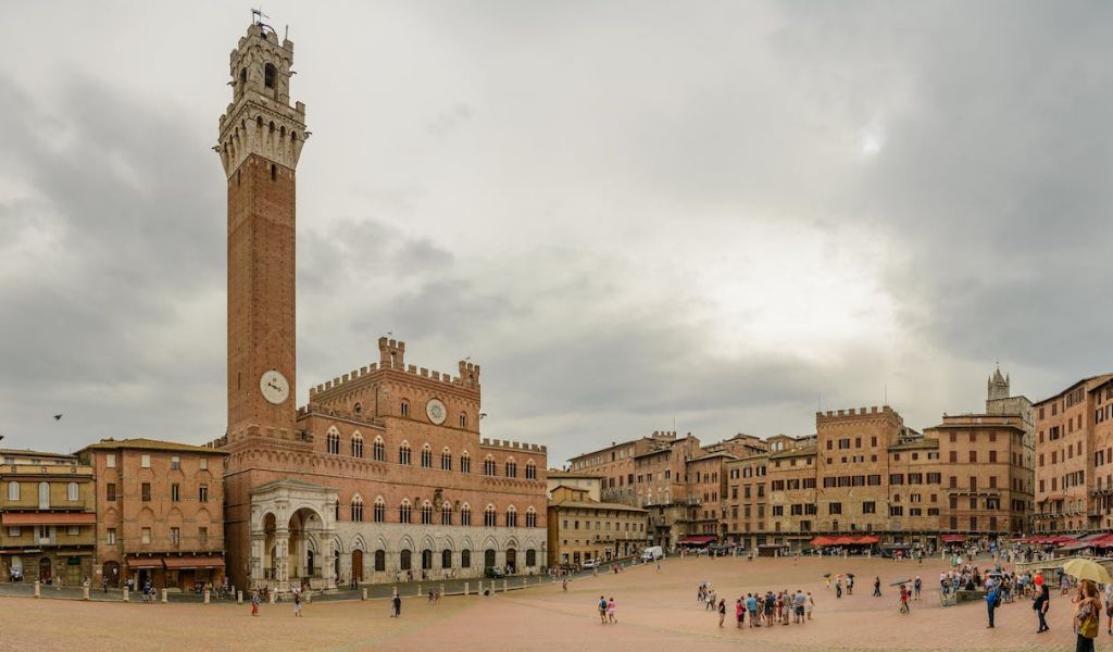Tourists visit the famous Piazza del Campo, Siena, Tuscany.