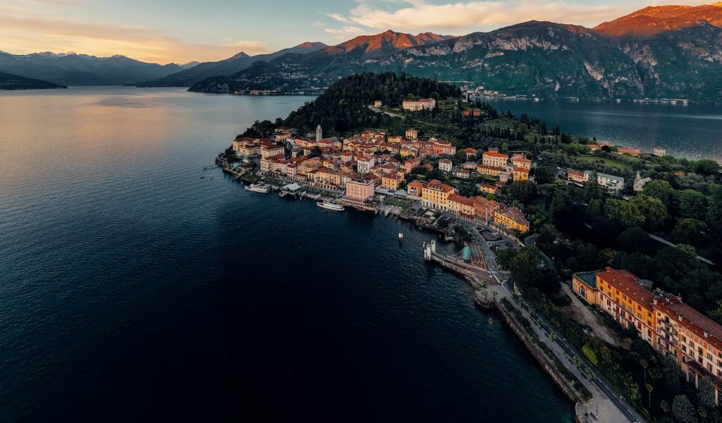 Aerial view of a beautiful village with sunset strikes on the mountain in Lake Como.