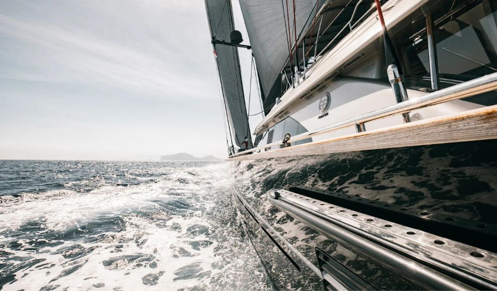 A black and white luxury yacht sailing on the beautiful sea of the Amalfi coast.