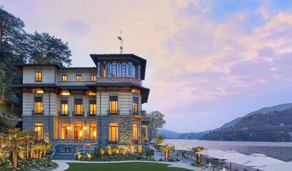 A luxury hotel near the lake with a beautiful view of the mountains located in Lake Como.
