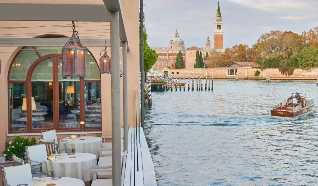 A luxury hotel with a beautiful view of structures near the lagoon in Hotel Cipriani, Venice