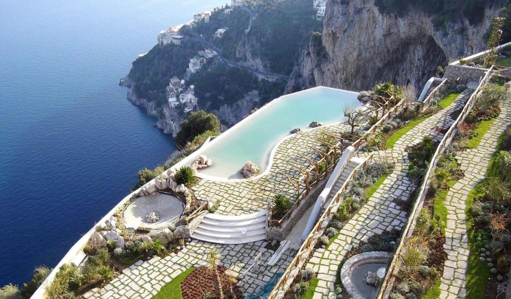 A luxury hotel on the cliff with a pool and view of the coast located in Monastero Santa Rosa, Amalfi Coast