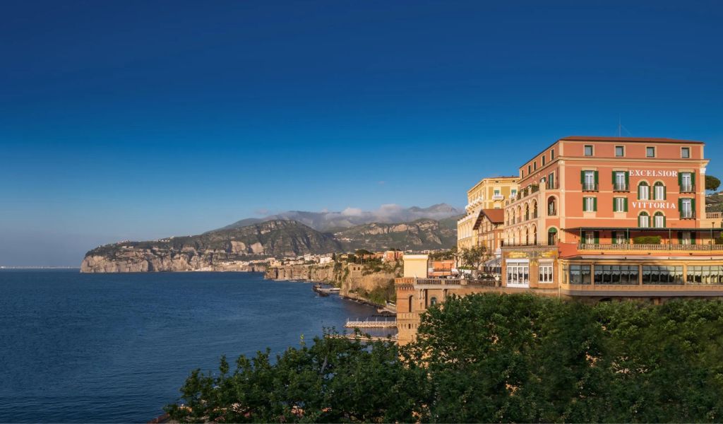 A view of the grand hotel Excelsior Vittoria and beautiful mountains above the sea in Italy