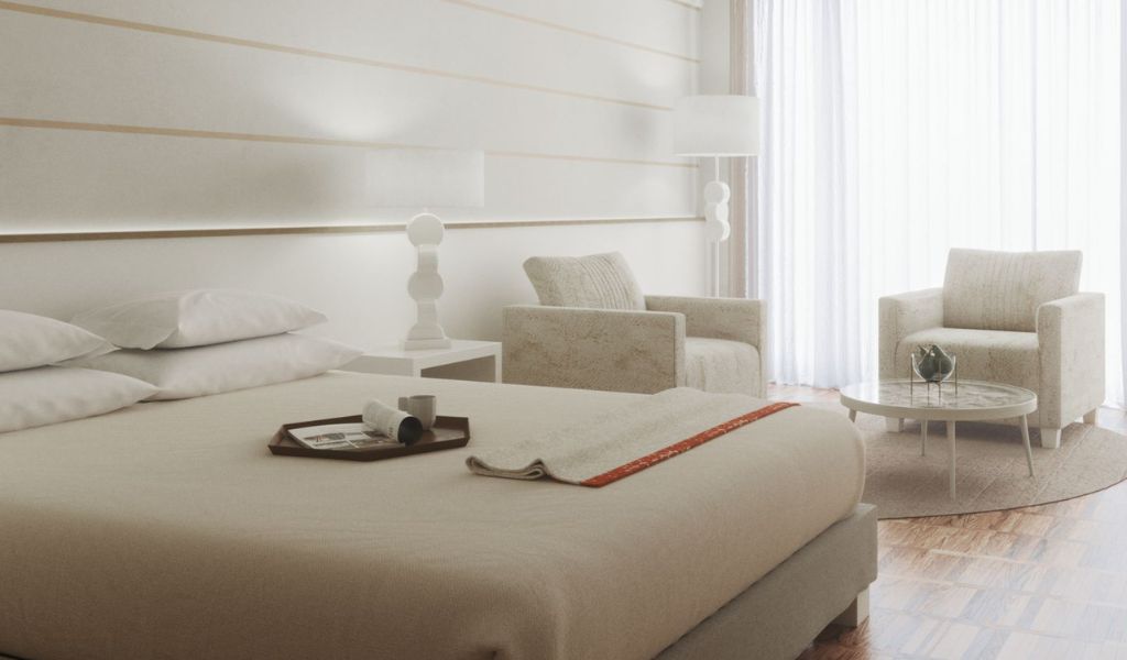 A white luxury hotel bedroom with a relaxing atmosphere in Lefay Resort