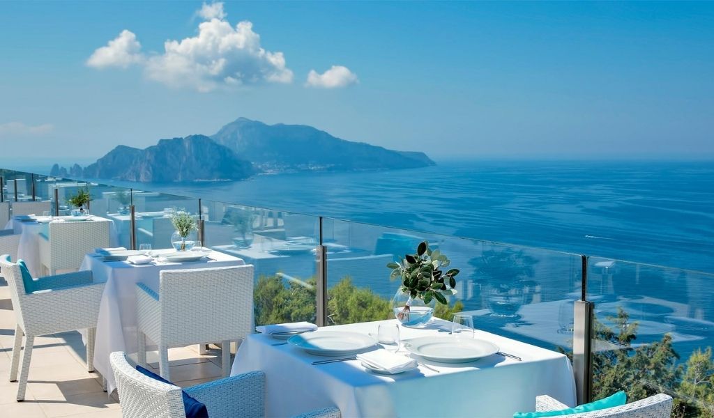 Experience unique dining in The Relais Blue in Mass with a view of the blue sea and mountains.