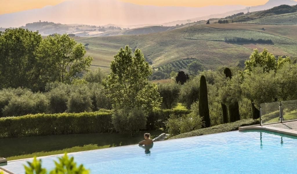A tourist enjoys the stunning view of landscapes while bathing in the Fonteverde Spa.