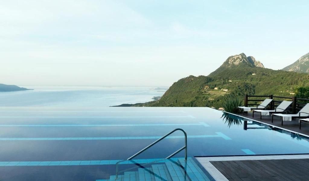 A contemporary pool with mountains view in Lefay resorts.